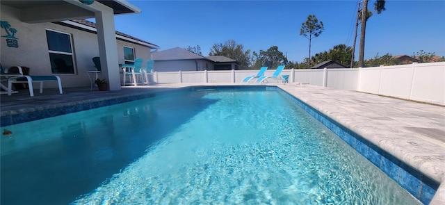 view of pool with a fenced in pool, a fenced backyard, and a patio area