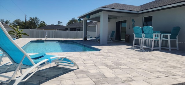 view of pool with a fenced in pool, a patio, a fenced backyard, and a ceiling fan