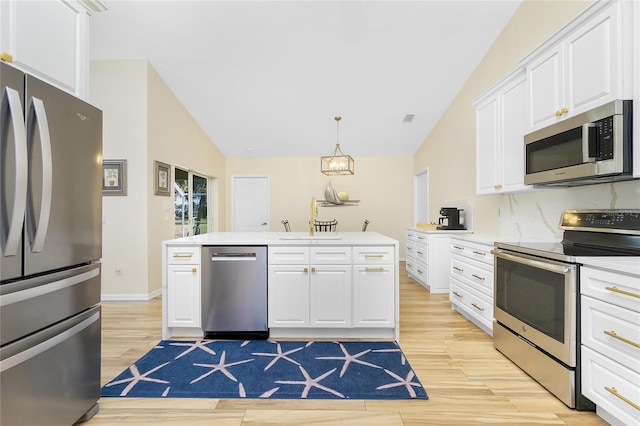 kitchen featuring light countertops, light wood-style flooring, appliances with stainless steel finishes, white cabinetry, and a sink