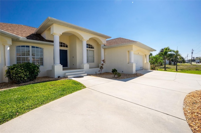 view of front of house featuring stucco siding, a garage, concrete driveway, and a shingled roof