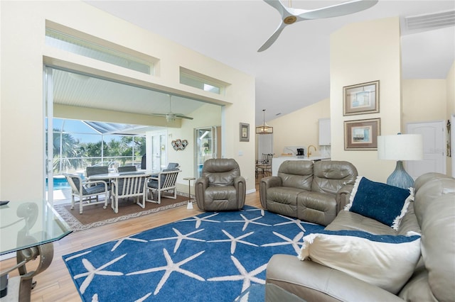 living area with visible vents, wood finished floors, ceiling fan, and a sunroom