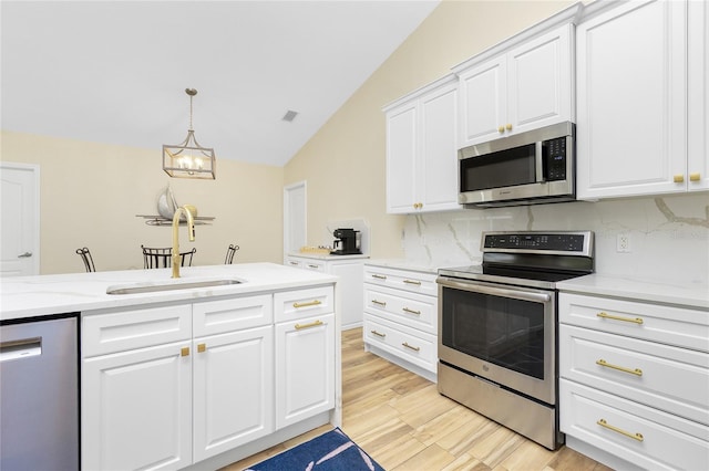 kitchen featuring tasteful backsplash, visible vents, light wood-style flooring, appliances with stainless steel finishes, and a sink