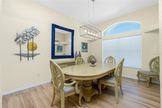 dining area with light wood finished floors and baseboards