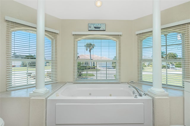 full bath with a jetted tub and decorative columns