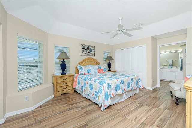 bedroom featuring a closet, baseboards, visible vents, and light wood finished floors