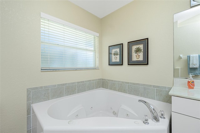 bathroom with a jetted tub and vanity