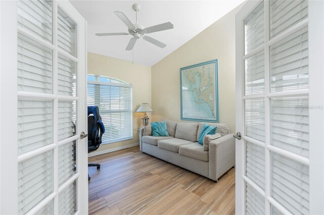 office area with a ceiling fan, vaulted ceiling, and light wood-style floors