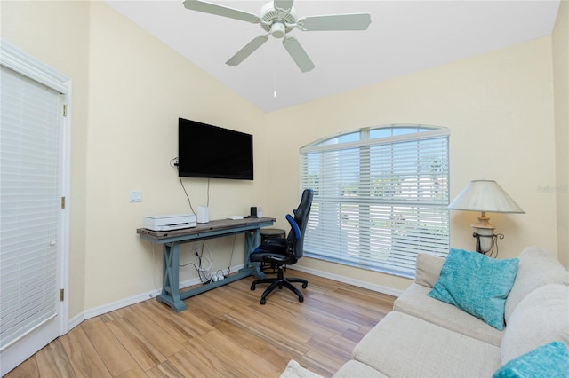 home office featuring vaulted ceiling, wood finished floors, and baseboards