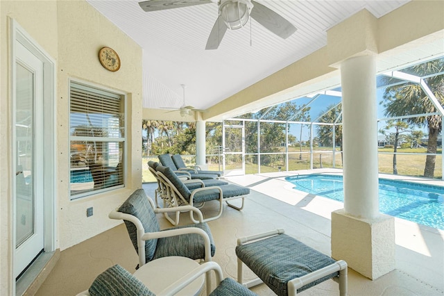 pool with a patio, a lanai, and a ceiling fan