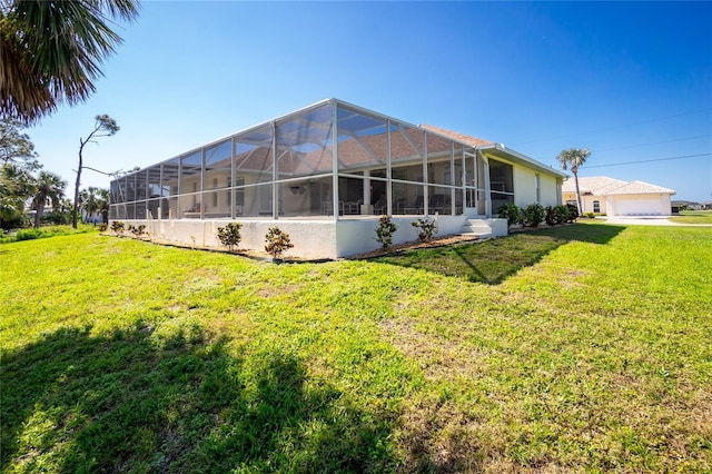 back of house featuring glass enclosure, a lawn, and stucco siding