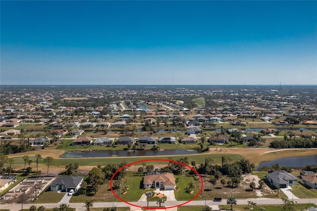 drone / aerial view with a residential view and a water view