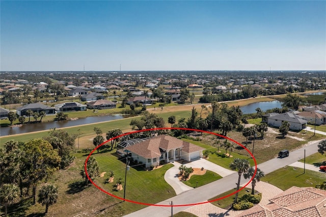 bird's eye view featuring a residential view and a water view