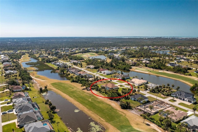 aerial view with a residential view, a water view, and view of golf course