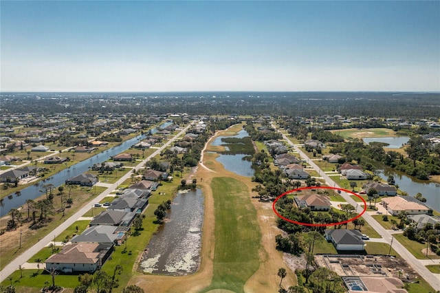 drone / aerial view with a water view and a residential view