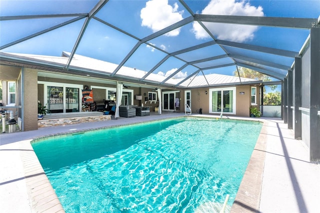 pool featuring glass enclosure, a patio, a ceiling fan, french doors, and outdoor lounge area