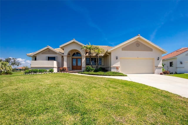 single story home with stucco siding, driveway, french doors, a front yard, and a garage