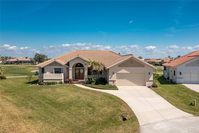 mediterranean / spanish house with stucco siding, french doors, a tile roof, and a front lawn