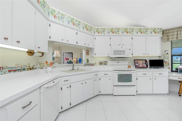 kitchen with white appliances, white cabinets, light countertops, and a sink