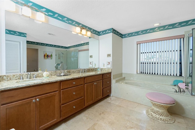 bathroom with a sink, a garden tub, double vanity, and a shower stall