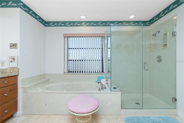 bathroom featuring a bath, tile patterned flooring, a stall shower, and vanity