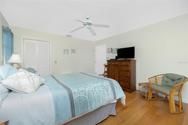 bedroom featuring a closet, visible vents, light wood-type flooring, and a ceiling fan