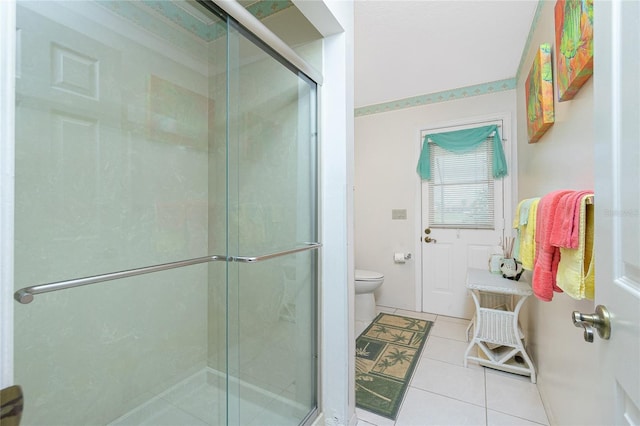 bathroom with tile patterned flooring, a stall shower, and toilet