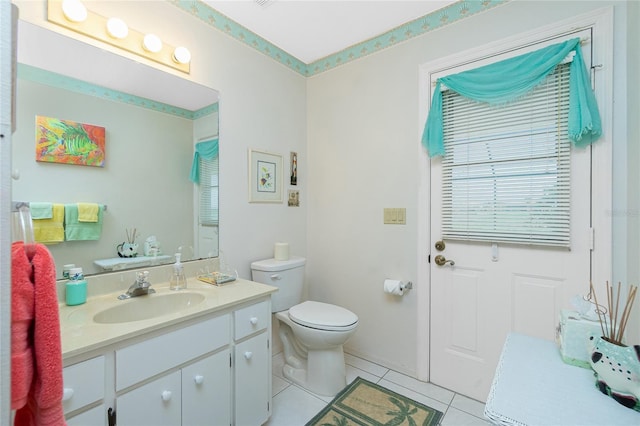 bathroom featuring toilet, vanity, and tile patterned flooring