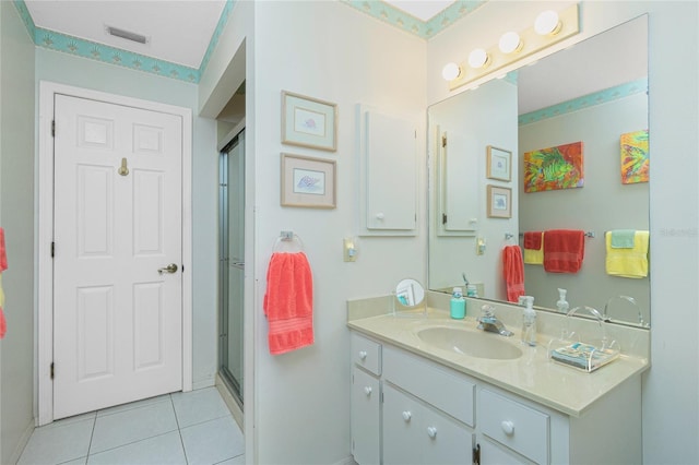 full bath featuring tile patterned floors, visible vents, vanity, and a shower stall