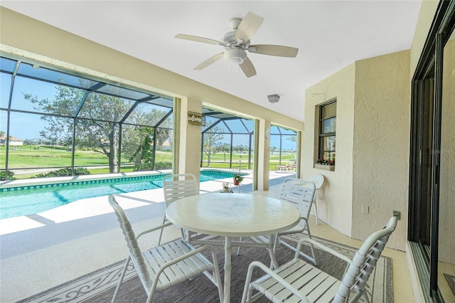 exterior space featuring a lanai, a ceiling fan, and a patio