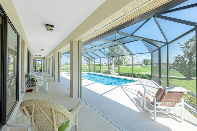 pool with a patio, a lawn, and a lanai