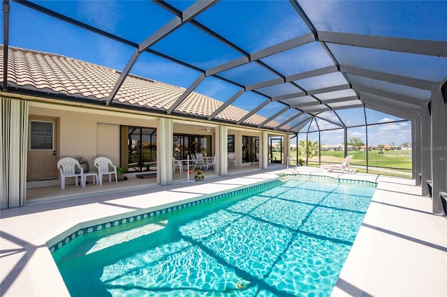 outdoor pool featuring a lanai, a ceiling fan, and a patio