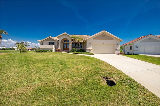 view of front of home featuring driveway, an attached garage, stucco siding, a front lawn, and french doors