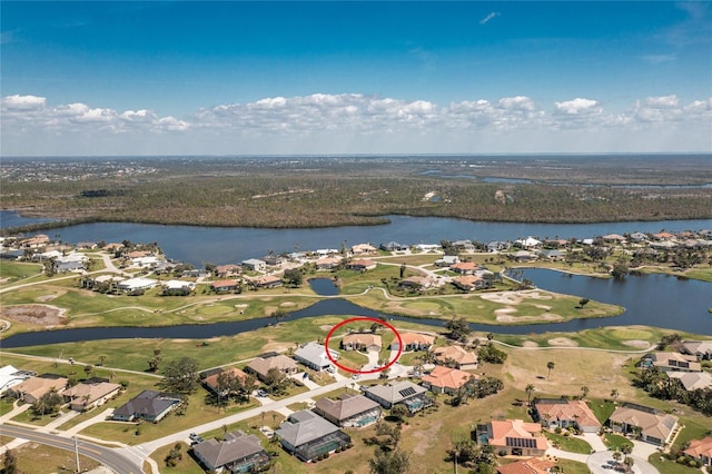 drone / aerial view featuring a residential view, a water view, and golf course view