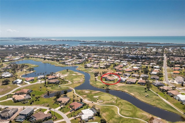 bird's eye view with view of golf course, a water view, and a residential view