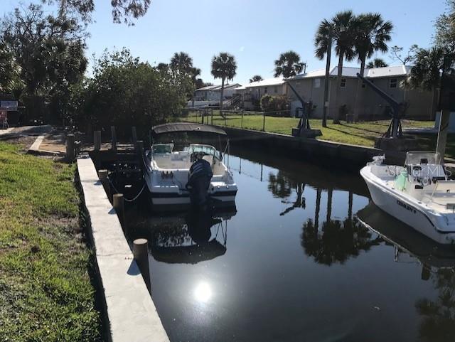 dock area with a yard and a water view