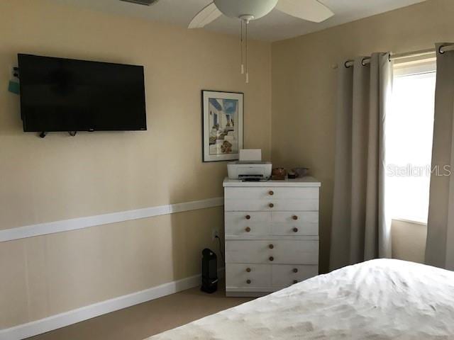 bedroom with baseboards and a ceiling fan