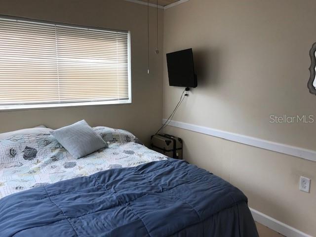 bedroom featuring baseboards and ornamental molding