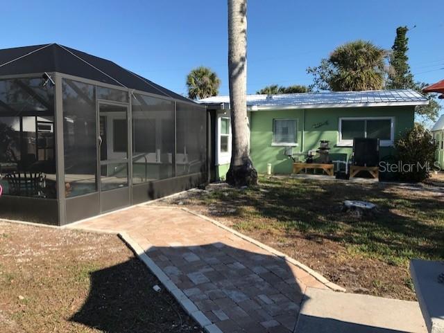 rear view of house with glass enclosure