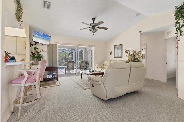 living room with vaulted ceiling, a ceiling fan, visible vents, and carpet floors