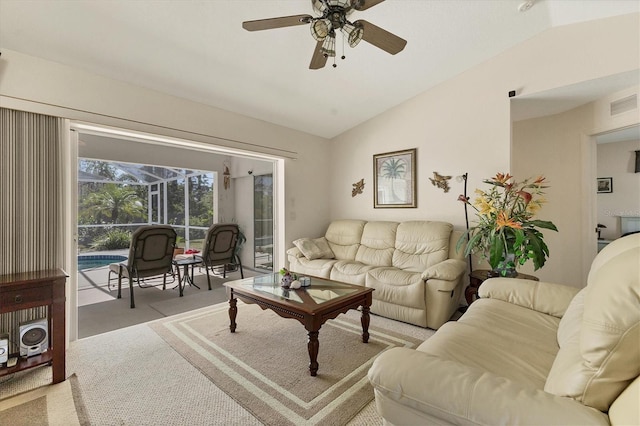 living area featuring visible vents, carpet floors, lofted ceiling, a sunroom, and ceiling fan