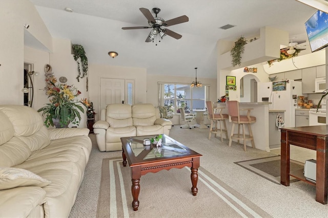 living area with visible vents, vaulted ceiling, carpet flooring, arched walkways, and a ceiling fan