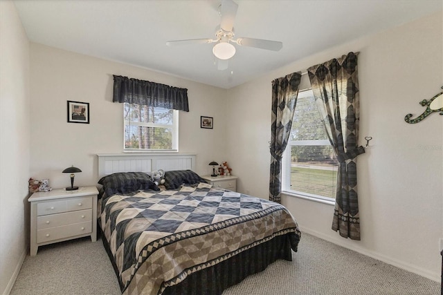 bedroom with baseboards, light carpet, and a ceiling fan