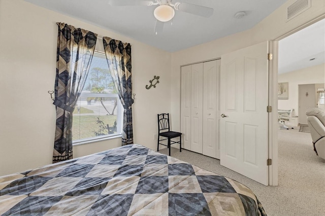 bedroom with a closet, carpet flooring, ceiling fan, and visible vents