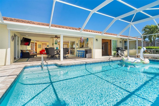 pool featuring a lanai, a grill, and a patio