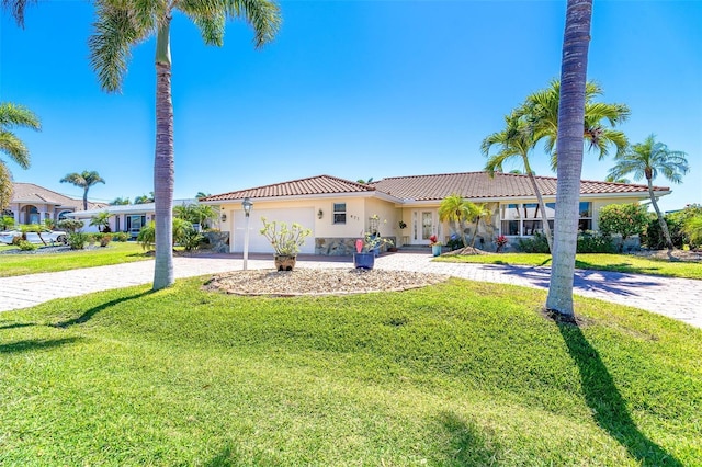 471 Capri Isles Ct, Punta Gorda, FL 33950 - view of front of house featuring a tile roof, curved driveway, an attached garage, a front yard, and stucco siding
