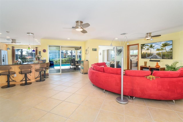 471 Capri Isles Ct, Punta Gorda, FL 33950 - living room with light tile patterned floors, visible vents, and ceiling fan