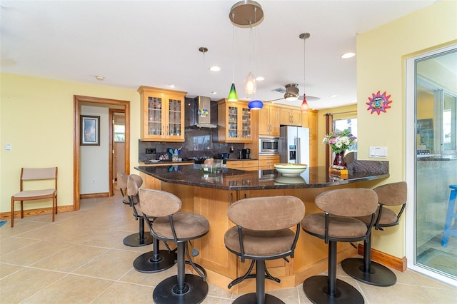 471 Capri Isles Ct, Punta Gorda, FL 33950 - kitchen featuring stainless steel appliances, baseboards, light tile patterned floors, and wall chimney range hood