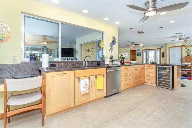 471 Capri Isles Ct, Punta Gorda, FL 33950 - kitchen featuring stainless steel dishwasher, a sink, ceiling fan, light brown cabinets, and beverage cooler