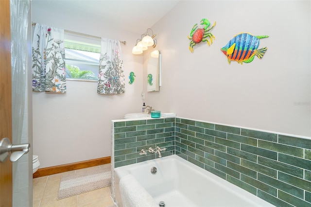 471 Capri Isles Ct, Punta Gorda, FL 33950 - full bath with tile patterned flooring, toilet, a sink, a bathing tub, and baseboards