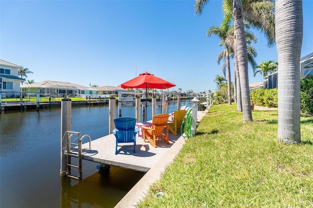 471 Capri Isles Ct, Punta Gorda, FL 33950 - dock area featuring a lawn and a water view